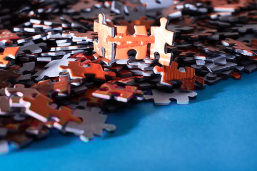 Mixed Pieces of a Colorful Jigsaw Puzzle Lie on the Blue Background - Strategy and Solving Problem Concept photo