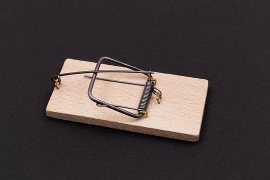 Wooden Mouse Trap. Empty Loaded Mousetrap on Black Background photo