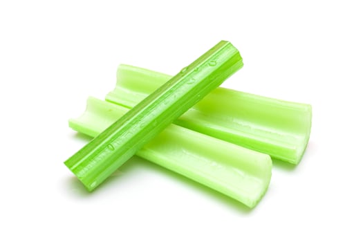 Fresh Chopped Celery Sticks with Water Drops Isolated on White Background. Vegan and Vegetarian Culture. Raw Food. Healthy Diet with Negative Calorie Content photo