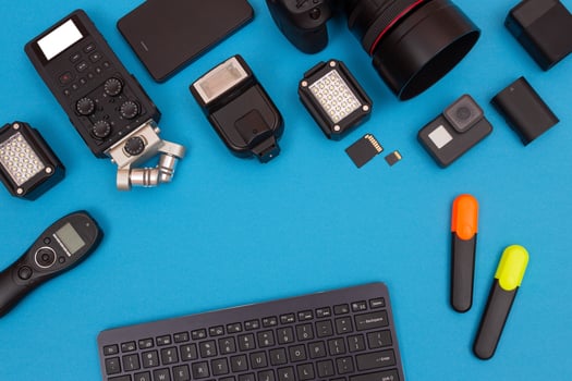 Top View of Photographer's, Videographer's or Blogger's Workplace. Digital Gadgets Lying on Blue Table - Flat Lay photo
