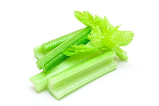 Fresh Chopped Celery Sticks with Water Drops Isolated on White Background. Vegan and Vegetarian Culture. Raw Food. Healthy Diet with Negative Calorie Content photo