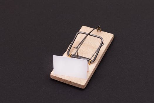 Blank White Sheet of Paper in Wooden Mousetrap - Template. Small Memo Paper in Mouse Trap on Black Background photo