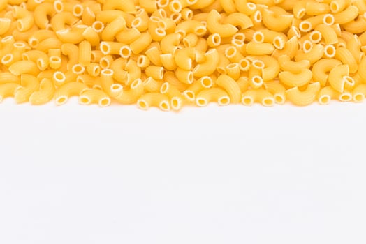 Uncooked Chifferi Rigati Pasta Scattered on White Table. Fat and Unhealthy Food. Classic Dry Macaroni. Italian Culture and Cuisine. Raw Pasta photo