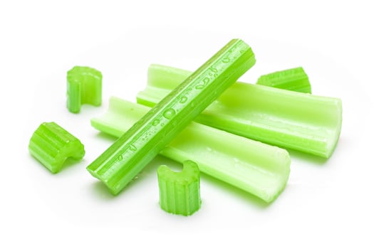 Fresh Chopped Celery Sticks and Slices with Water Drops Isolated on White Background. Vegan and Vegetarian Culture. Raw Food. Healthy Diet with Negative Calorie Content photo