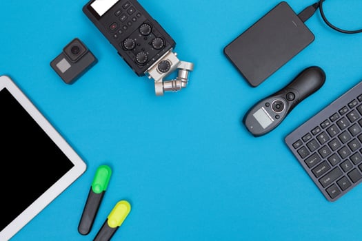 Top View of Photographer's, Videographer's or Blogger's Workplace. Digital Gadgets Lying on Blue Table - Flat Lay photo