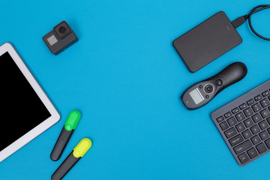 Top View of Photographer's, Videographer's or Blogger's Workplace. Digital Gadgets Lying on Blue Table - Flat Lay photo
