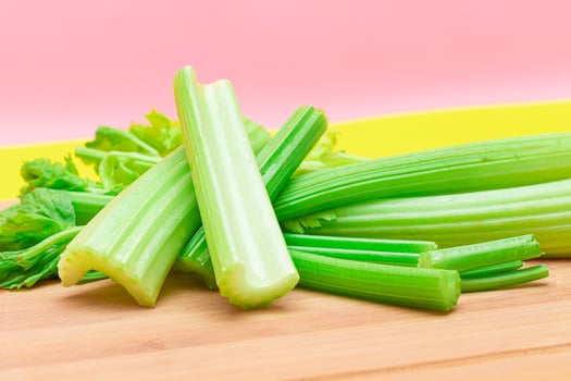 Fresh Celery Stem and Chopped Celery Sticks on Wooden Cutting Board. Vegan and Vegetarian Culture. Raw Food. Healthy Diet with Negative Calorie Content. Slimming Food photo