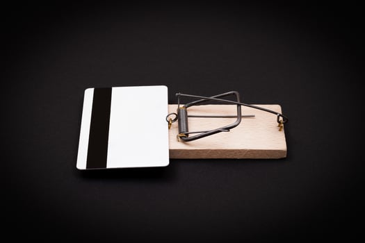 Credit Risk and Loan Trap - White Blank Credit Card Template in Wooden Mouse Trap on Black Background photo