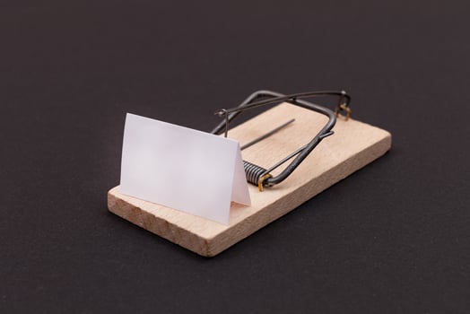 Blank White Sheet of Paper in Wooden Mousetrap - Template. Small Memo Paper in Mouse Trap on Black Background photo
