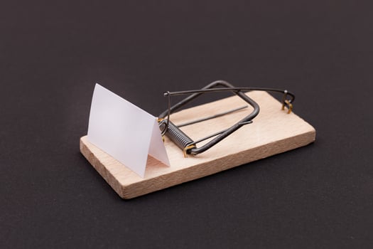 Blank White Sheet of Paper in Wooden Mousetrap - Template. Small Memo Paper in Mouse Trap on Black Background photo