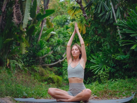 Beautiful woman practices yoga in Crabi, Thailand photo
