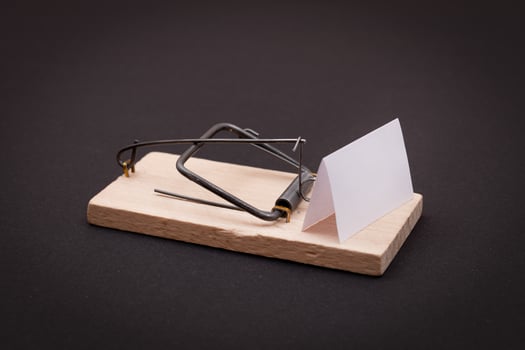 Blank White Sheet of Paper in Wooden Mousetrap - Template. Small Memo Paper in Mouse Trap on Black Background photo