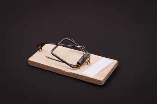 Blank White Sheet of Paper in Wooden Mousetrap - Template. Small Memo Paper in Mouse Trap on Black Background photo
