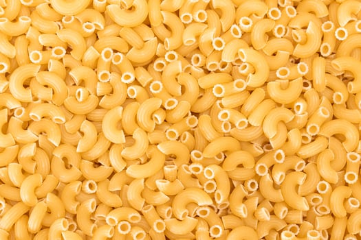 Uncooked Chifferi Rigati Pasta Background. Fat and Unhealthy Food. Classic Dry Macaroni Texture. Italian Culture and Cuisine. Raw Pasta photo
