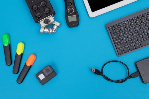 Top View of Photographer's, Videographer's or Blogger's Workplace. Digital Gadgets Lying on Blue Table - Flat Lay photo