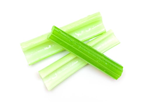 Fresh Chopped Celery Sticks with Water Drops Isolated on White Background. Vegan and Vegetarian Culture. Raw Food. Healthy Diet with Negative Calorie Content photo