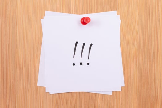 White Sticky Notes with Three Exclamation Points Pinned to the Wooden Message Board. To Do List Reminder in the Office. Memo Note at Work photo