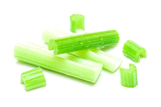 Fresh Chopped Celery Sticks and Slices with Water Drops Isolated on White Background. Vegan and Vegetarian Culture. Raw Food. Healthy Diet with Negative Calorie Content photo