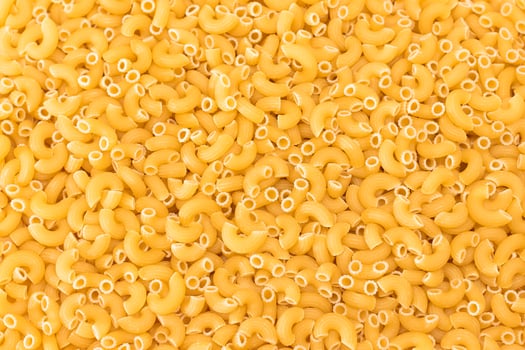 Uncooked Chifferi Rigati Pasta Background. Fat and Unhealthy Food. Classic Dry Macaroni Texture. Italian Culture and Cuisine. Raw Pasta photo