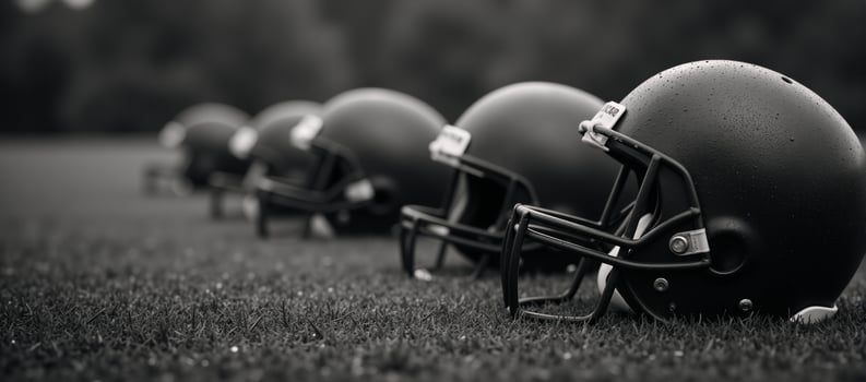 Worn football helmets on rainsoaked field with bokeh light effects photo