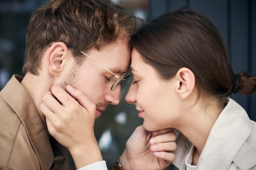 Young couple touching foreheads enjoying intimate moment photo