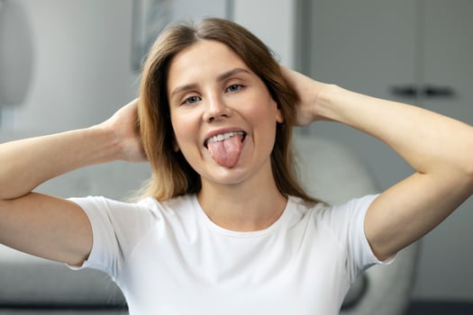 Portrait of a young woman sticking out her tongue photo
