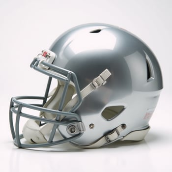 Highangle view Shiny silver football helmet with facemask and white pads photo