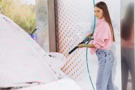 Young Woman Washing Car at Self-Service Car Wash photo