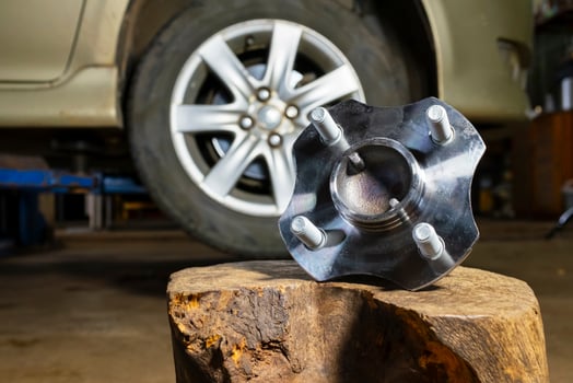 The auto mechanic is replacing the wheel bearings.The wheel bearing is broken and the mechanic is fixing it. photo