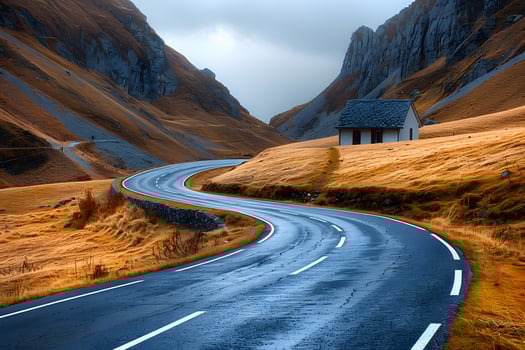 Serene Mountain Road in Autumn with Winding Path and Cozy Cabin Landscape photo