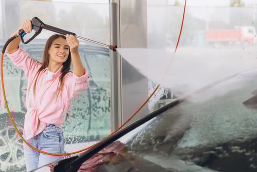 Young Woman Smiling While Washing Car at a Self-Service Station photo