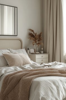 Cozy bedroom with neutral decor, soft linens, and natural light shining through the window photo
