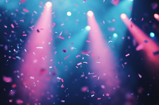 Colorful confetti shower under vibrant stage lights during a lively celebration photo