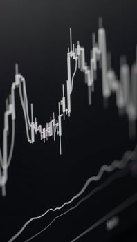 Uptrend line graph candlesticks displayed on an abstract finance chart with BW backdrop photo