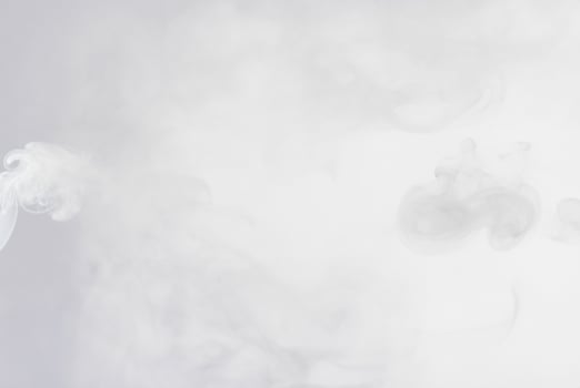 Soft white smoke or mist floating on a light background, perfect for abstract, atmospheric, or ethereal designs. photo