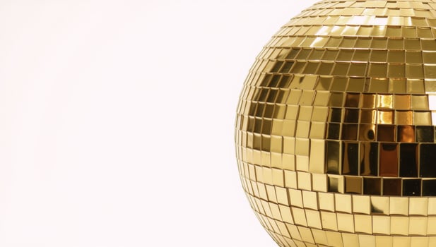 Gold Disco Ball against White Backdrop photo