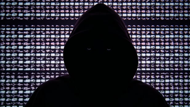 Hacker in hood against glitchy computer code backdrop Glitch Art Style photo