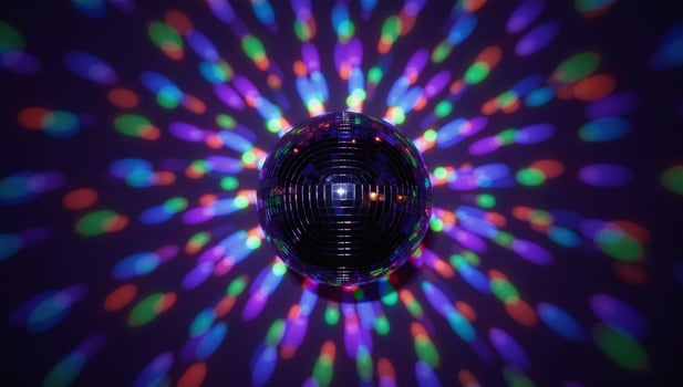 A glittery disco ball surrounded by vibrant disco lights photo
