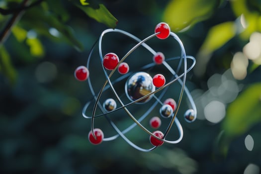 A metallic sphere with red and silver balls on it photo