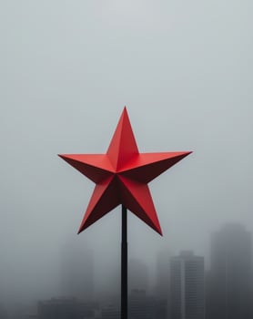 A red star on top of a building in the fog photo