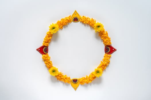 Decorative orange color marigold flowers and petals rangoli for Diwali festival with white space background. photo