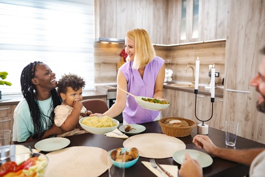 Family gathers in a cozy kitchen for a meal photo