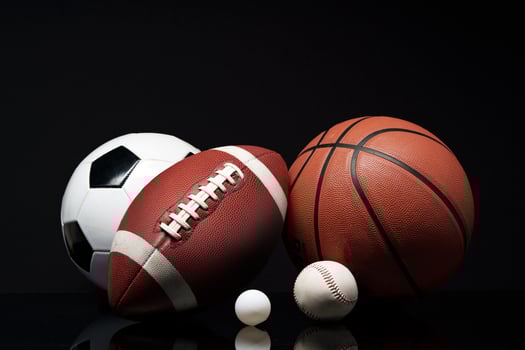 Various sports equipment on black background studio shot photo
