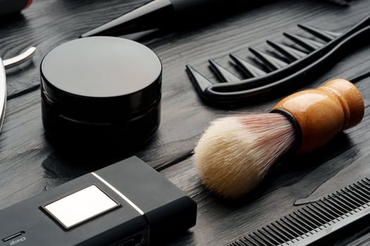 Professional Barber Tools Laid Out on Dark Wooden Surface photo