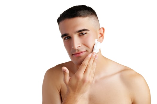 Young handsome man applying shaving foam against white background photo