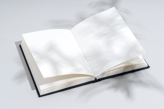 Blank open notepad on gray background studio shot photo
