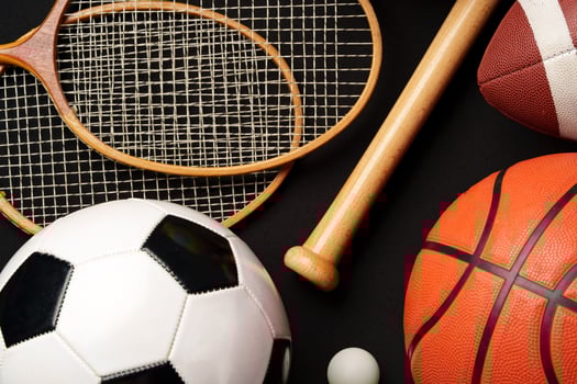Various sports equipment on black background studio shot photo
