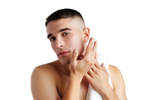 Young attractive brunet guy with perfect skin touching chin on white background photo