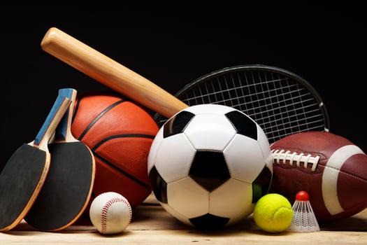 Various sports equipment on black background studio shot photo