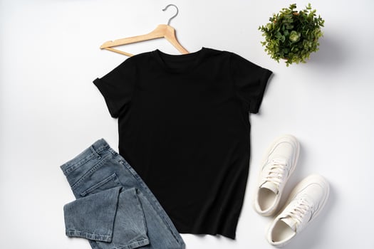 T-shirt, jeans and white sneakers on gray background top view photo